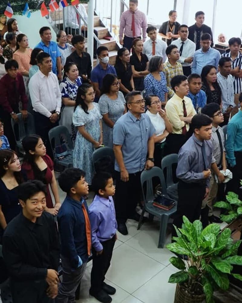 The congregation standing for worship on a Sunday morning